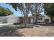 Single-story home with a brick exterior, front yard, and trees at 8391 76Th Ave, Seminole, FL 33777