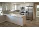 Modern kitchen featuring white shaker cabinets, stainless steel appliances, and a white quartz countertop at 8391 76Th Ave, Seminole, FL 33777