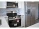 Updated kitchen with stainless steel appliances, white cabinets, and subway tile backsplash at 8391 76Th Ave, Seminole, FL 33777