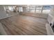 Spacious living room with wood-look floors and large windows at 8391 76Th Ave, Seminole, FL 33777