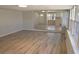 Living room with wood-look flooring, neutral walls, and sliding doors that offer a glimpse into the kitchen at 8391 76Th Ave, Seminole, FL 33777