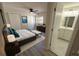 Main bedroom featuring a king bed and ensuite bathroom, creating a private retreat with a serene atmosphere and functional design at 8391 76Th Ave, Seminole, FL 33777
