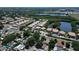 Aerial view showcasing a community of townhomes with a shared pool adjacent to a natural water body at 8391 76Th Ave, Seminole, FL 33777