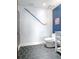 Stylish bathroom boasts a white vanity, blue accent wall, and eye-catching hexagon tile flooring at 912 Channelside Dr # 2412, Tampa, FL 33602