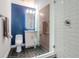 Modern bathroom with white subway tile, glass shower, and a dark blue accent wall at 912 Channelside Dr # 2412, Tampa, FL 33602