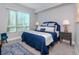 Inviting bedroom featuring blue and white decor, ample natural light, and a comfortable sitting area at 912 Channelside Dr # 2412, Tampa, FL 33602