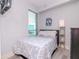 Simply decorated bedroom featuring a bed, dark wood dresser, and window with blinds at 912 Channelside Dr # 2412, Tampa, FL 33602