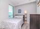 Cozy bedroom with a comfortable bed, wood dresser, and a large window at 912 Channelside Dr # 2412, Tampa, FL 33602