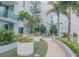 Tranquil courtyard with lush landscaping, a water feature, and a paved walkway at 912 Channelside Dr # 2412, Tampa, FL 33602