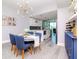 Dining area with round table, blue chairs, a bar area, and kitchen view at 912 Channelside Dr # 2412, Tampa, FL 33602
