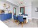 Dining area with blue chairs, a round table, a bar, and frosted glass doors at 912 Channelside Dr # 2412, Tampa, FL 33602