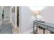 Hallway with a console table, laundry closet, and patterned rug at 912 Channelside Dr # 2412, Tampa, FL 33602