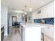Modern kitchen with white cabinets, marble countertops, gold hardware, and blue tile backsplash at 912 Channelside Dr # 2412, Tampa, FL 33602