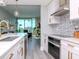 Bright, white kitchen featuring stainless steel appliances and patterned backsplash at 912 Channelside Dr # 2412, Tampa, FL 33602
