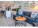 Open-concept living area with blue sofa, wood coffee table, and view of the adjacent kitchen at 912 Channelside Dr # 2412, Tampa, FL 33602