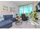 Inviting living room with a blue sectional sofa, balcony access, and modern decor at 912 Channelside Dr # 2412, Tampa, FL 33602