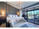 Main bedroom with a cozy sitting area and balcony access at 9487 Tara Cay Ct, Seminole, FL 33776