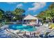 Inviting community pool with lounge chairs and covered seating area at 9487 Tara Cay Ct, Seminole, FL 33776