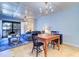 Dining area with farmhouse table, chandelier and access to balcony at 9487 Tara Cay Ct, Seminole, FL 33776
