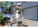 Garage entry with white door and decorative archway at 9487 Tara Cay Ct, Seminole, FL 33776