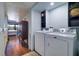 Well-lit laundry room with washer and dryer, and ample shelf space at 9487 Tara Cay Ct, Seminole, FL 33776