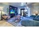 Spacious living room with comfy seating, a large TV, and access to a balcony at 9487 Tara Cay Ct, Seminole, FL 33776