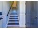 Interior staircase with tile accents and dark wood at 9487 Tara Cay Ct, Seminole, FL 33776