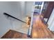 Stairs leading to lower level, with hardwood flooring throughout at 9487 Tara Cay Ct, Seminole, FL 33776