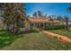 Charming exterior of a single-story home showcasing a covered front porch and well-manicured landscaping at 1055 Riverside Ridge Rd, Tarpon Springs, FL 34688