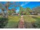 Charming home with lush front yard and brick walkway at 1055 Riverside Ridge Rd, Tarpon Springs, FL 34688