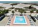 Sparkling blue community pool with ample lounge chairs, beach views at 11000 Gulf Blvd # 703, Treasure Island, FL 33706