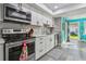 Modern kitchen featuring white cabinetry, stainless steel appliances, and a door to the backyard at 11200 102Nd Ave # 90, Seminole, FL 33778