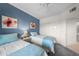 Serene bedroom with two twin beds and blue accent wall at 1200 Gulf Blvd # 206, Clearwater, FL 33767