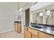 Bathroom featuring dual sinks with granite countertops, tile floors, and a large shower at 12119 Hunters Lake Dr, New Port Richey, FL 34654