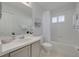 Bathroom with shower and bath featuring a vanity with white cabinets and a large mirror at 13336 Ashbark Ct, Riverview, FL 33579