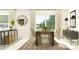 Modern dining room with a wooden table, wicker chairs, and sliding glass doors at 15129 Rainbow Quartz St, Wimauma, FL 33598