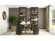 Stylish home office with a dark accent wall, built-in shelving, and a modern desk at 15129 Rainbow Quartz St, Wimauma, FL 33598
