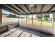 Covered back porch with views of the fenced backyard at 1536 77Th N Ave, St Petersburg, FL 33702