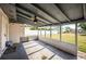 Large, covered back porch with a ceiling fan and backyard access at 1536 77Th N Ave, St Petersburg, FL 33702