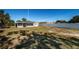 Backyard view showcasing the home's exterior and a grassy area at 1536 77Th N Ave, St Petersburg, FL 33702