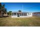 Exterior view of a one-story home with a grassy backyard at 1536 77Th N Ave, St Petersburg, FL 33702