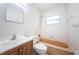 Bathroom with beige tiled tub/shower, white sink, and wood vanity at 1536 77Th N Ave, St Petersburg, FL 33702