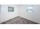 Empty bedroom with gray carpet and two windows at 1536 77Th N Ave, St Petersburg, FL 33702
