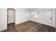 A bedroom with wood-look tile flooring, white walls, and natural light at 1536 77Th N Ave, St Petersburg, FL 33702