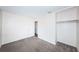 Empty bedroom with plush gray carpet, closet and door to another room at 1536 77Th N Ave, St Petersburg, FL 33702