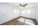 Empty bedroom with wood-look tile floors, ceiling fan, and multiple windows at 1536 77Th N Ave, St Petersburg, FL 33702