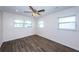 Empty bedroom with wood-look tile floors and multiple windows at 1536 77Th N Ave, St Petersburg, FL 33702