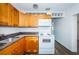 Kitchen featuring wood cabinets, granite countertops, and white appliances at 1536 77Th N Ave, St Petersburg, FL 33702