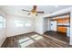 Living area with wood-look tile, ceiling fan, and view of the kitchen at 1536 77Th N Ave, St Petersburg, FL 33702