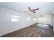 Open and spacious living area with wood-look tile floors and ceiling fans at 1536 77Th N Ave, St Petersburg, FL 33702